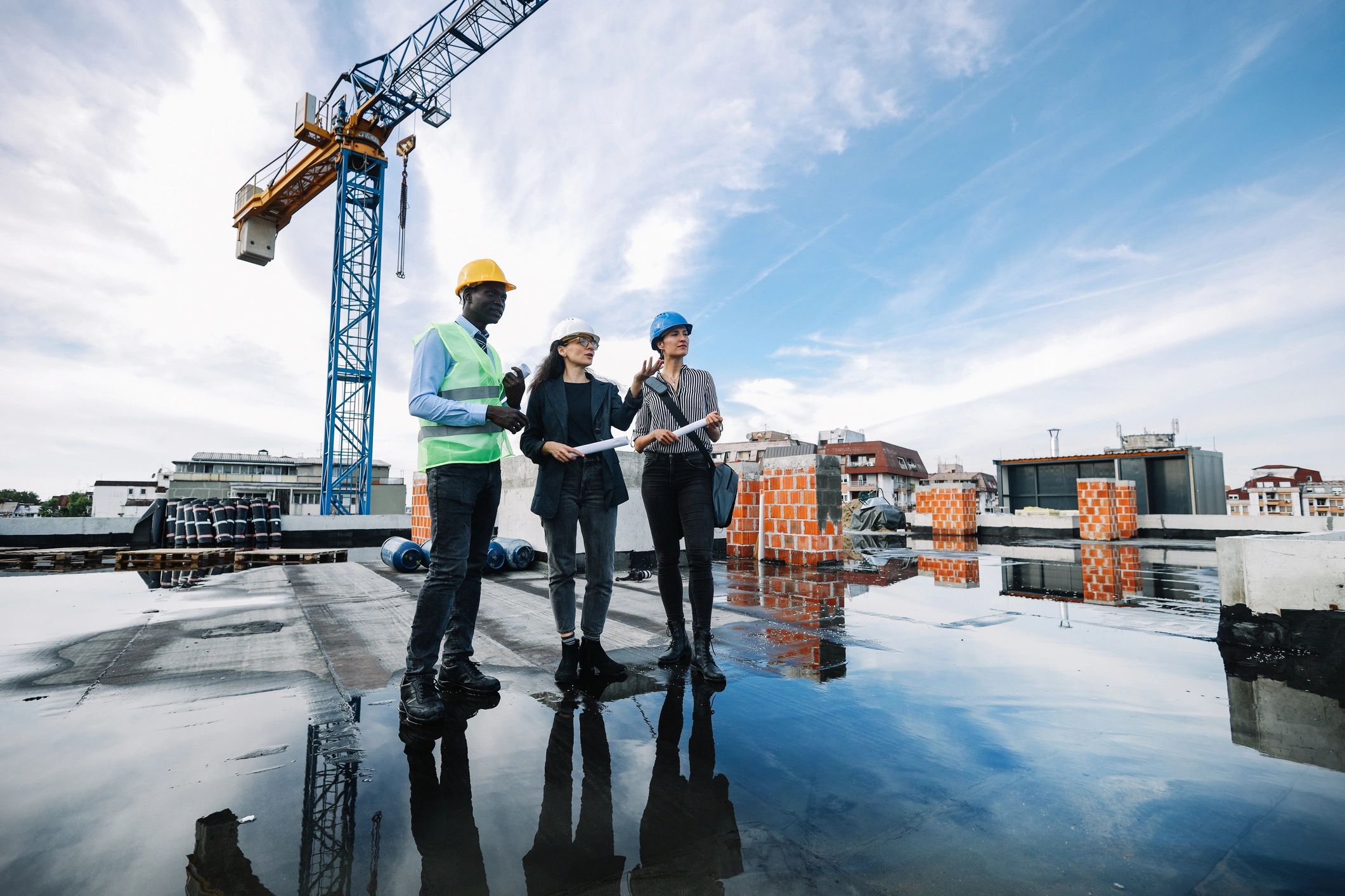 Architects reviewing plans together on an active project site